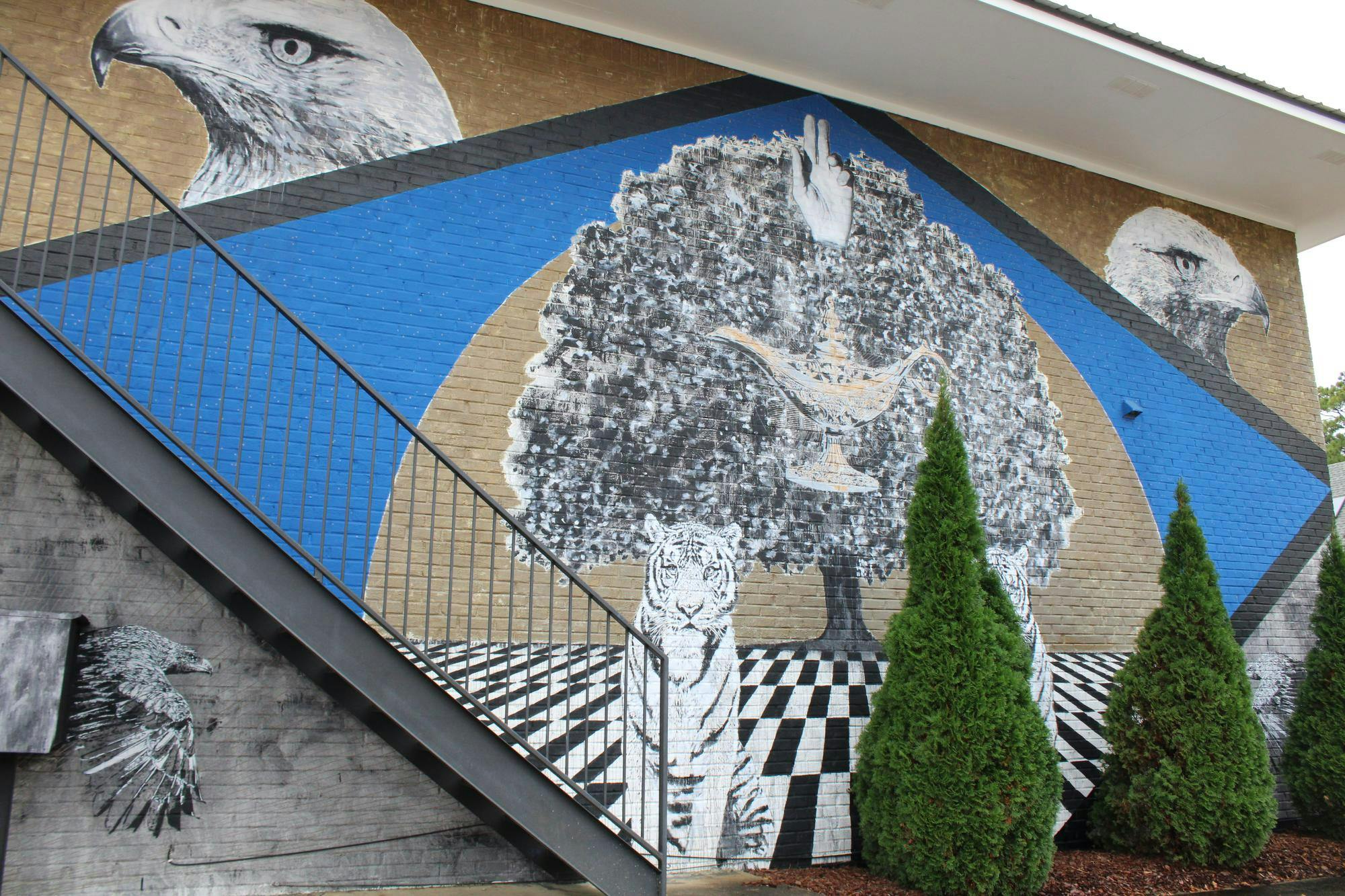 "Auburn Animal Icons" is a mural on the side of an apartment complex right behind Momma Goldberg's Delicatessen on N Donahue Dr depicting a tiger and several eagles. 