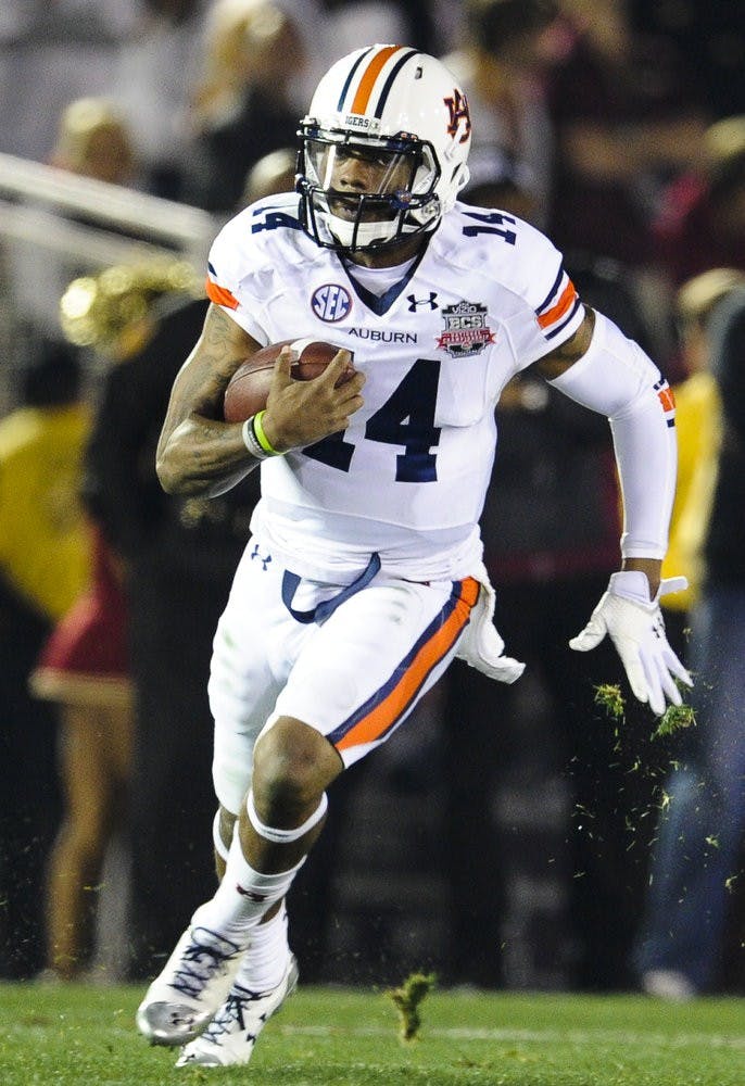 Auburn quarterback Nick Marshall (14) runs down the field against Florida State, Pasadena, Calif., Jan. 6, 2014. (Zach Bland / Assistant Photo Editor)