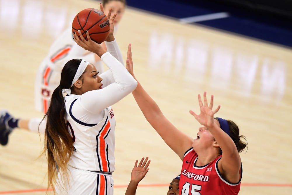 <p>Unique Thompson (20) shoots over Natalie Armstrong (45) during the game between Auburn and Samford at Auburn Arena on Nov 28, 2020; Auburn, AL, USA. Photo via: Shanna Lockwood/AU Athletics</p>