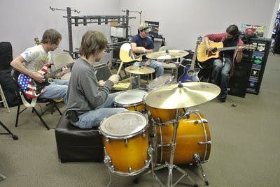 Leonard plays the drums during a jam session at The Guitar Shoppe. (Kelsey Davis / INTRIGUE WRITER)