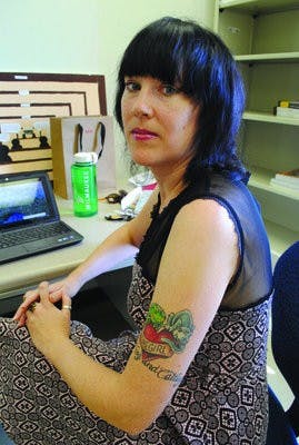 Professor Jennifer Collins sports a tattoo sharing the title of her novel, "Homegirl!" (Maria Iampietro / PHOTO EDITOR)