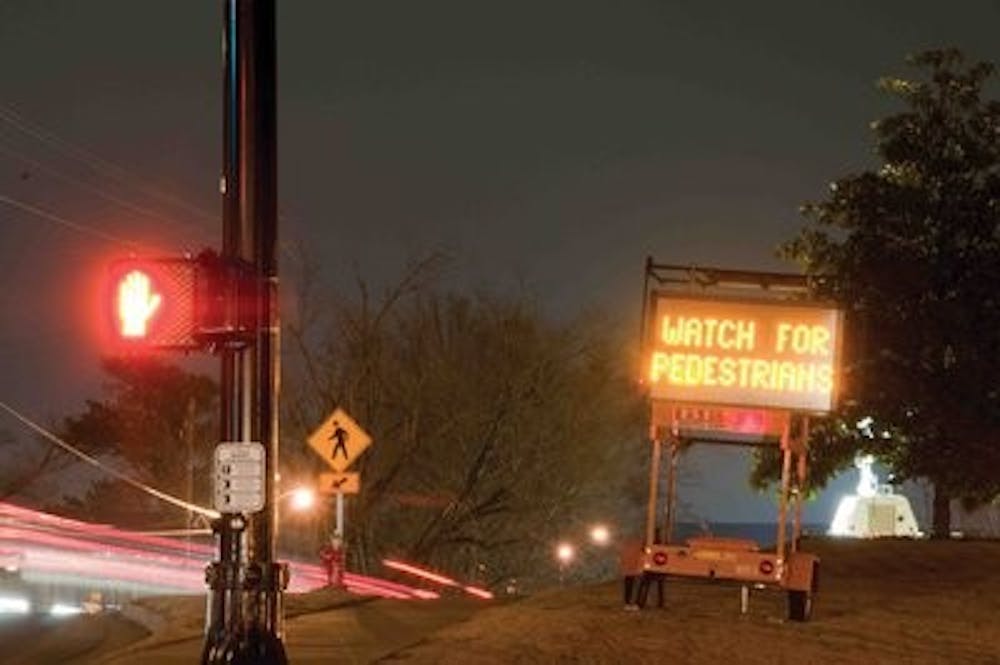 Many signs shine through the night to remind drivers and pedestrians to be safe on Magnolia Avenue. Philip Smith / ASSISTANT PHOTO EDITOR