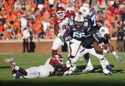 Senior running back Mario Fannin pushes through Arkansas' defense during Saturday's win. (Emily Adams / Photo Editor)