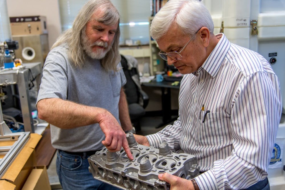<p>Lab technician Mike Crumpler, left, and materials engineering professor Tony Overfelt examine metal components in one of Auburn's additive manufacturing labs. Overfelt is director of the Center for Industrialized Additive Manufacturing and principal investigator on a separate $1.5 million grant from the National Institute of Standards and Technology to research ways for smaller manufacturers to incorporate additive technology into their processes.</p>
