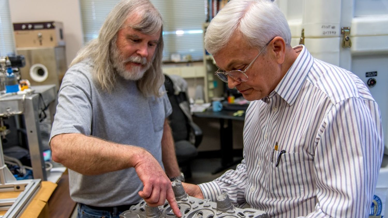 Lab technician Mike Crumpler, left, and materials engineering professor Tony Overfelt examine metal components in one of Auburn's additive manufacturing labs. Overfelt is director of the Center for Industrialized Additive Manufacturing and principal investigator on a separate $1.5 million grant from the National Institute of Standards and Technology to research ways for smaller manufacturers to incorporate additive technology into their processes.