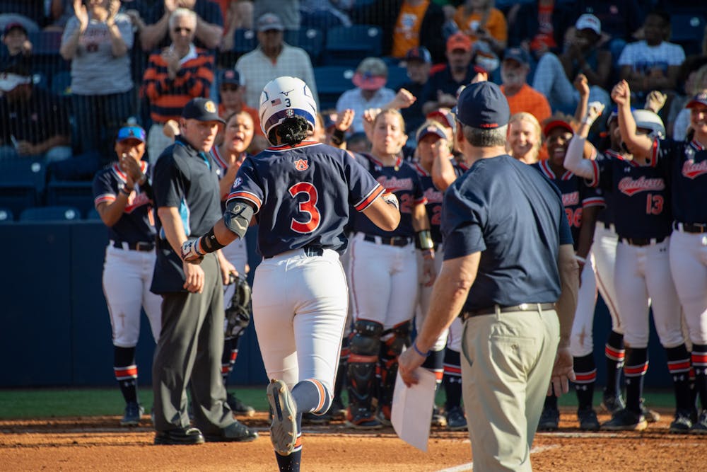 <p>Icess Tresvik (3) running to a home plate surrounded by her cheering teammates after hitting a home run in their second softball game against the Tennessee Lady Vols, March 30, 2024.</p>