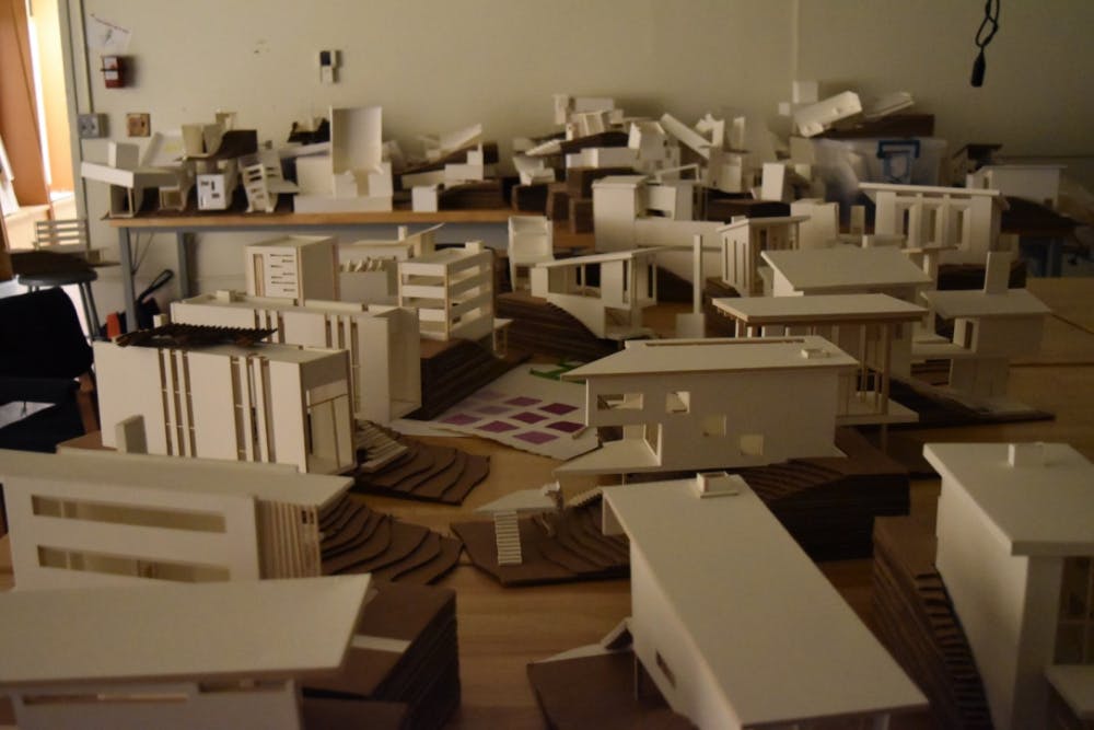Projects from a summer of architecture scattered around the room. 