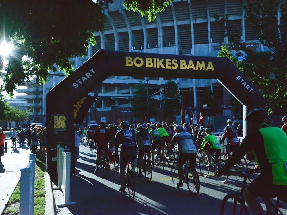 Bikers pass the starting line for Bo Bikes Bama on Saturday, April 27, 2019 in Auburn, Ala