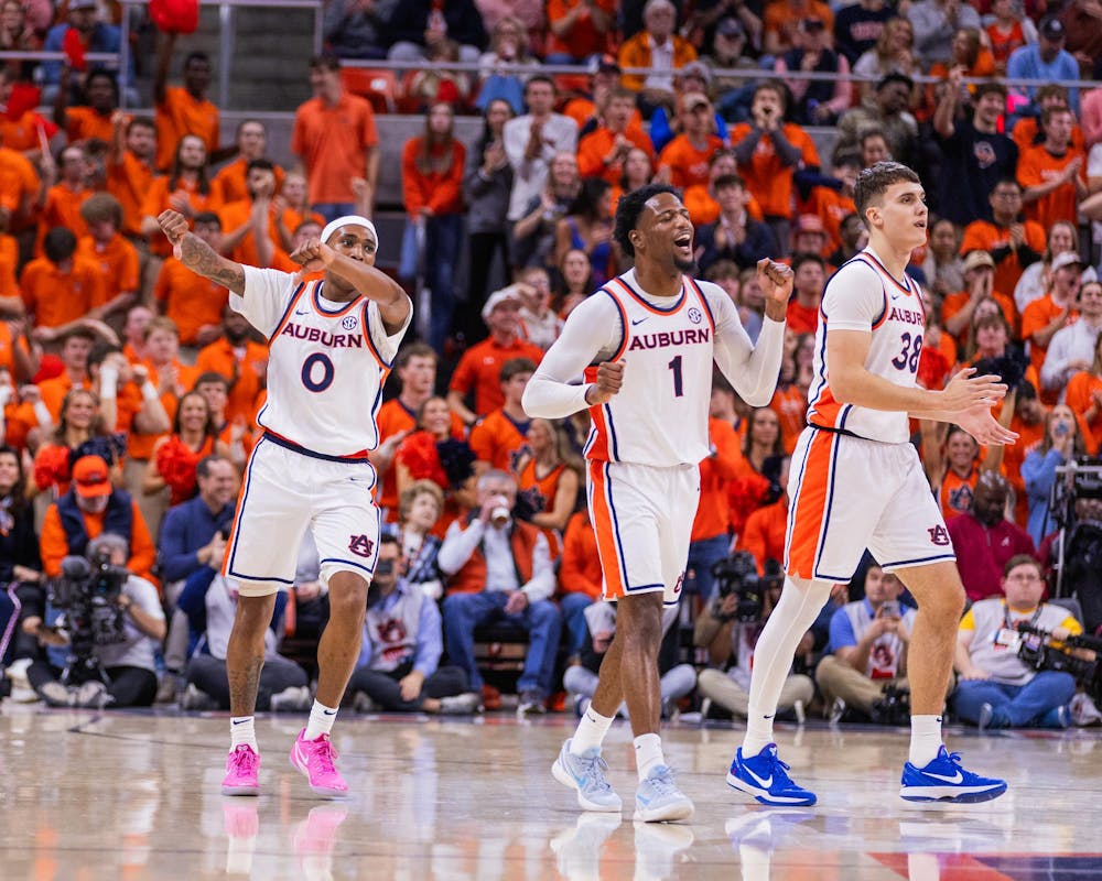 Tahaad Pettiford, Kevin Overton, and Filip Jovic celebrate a defensive stop against Alabama on Feb. 7, 2026. 