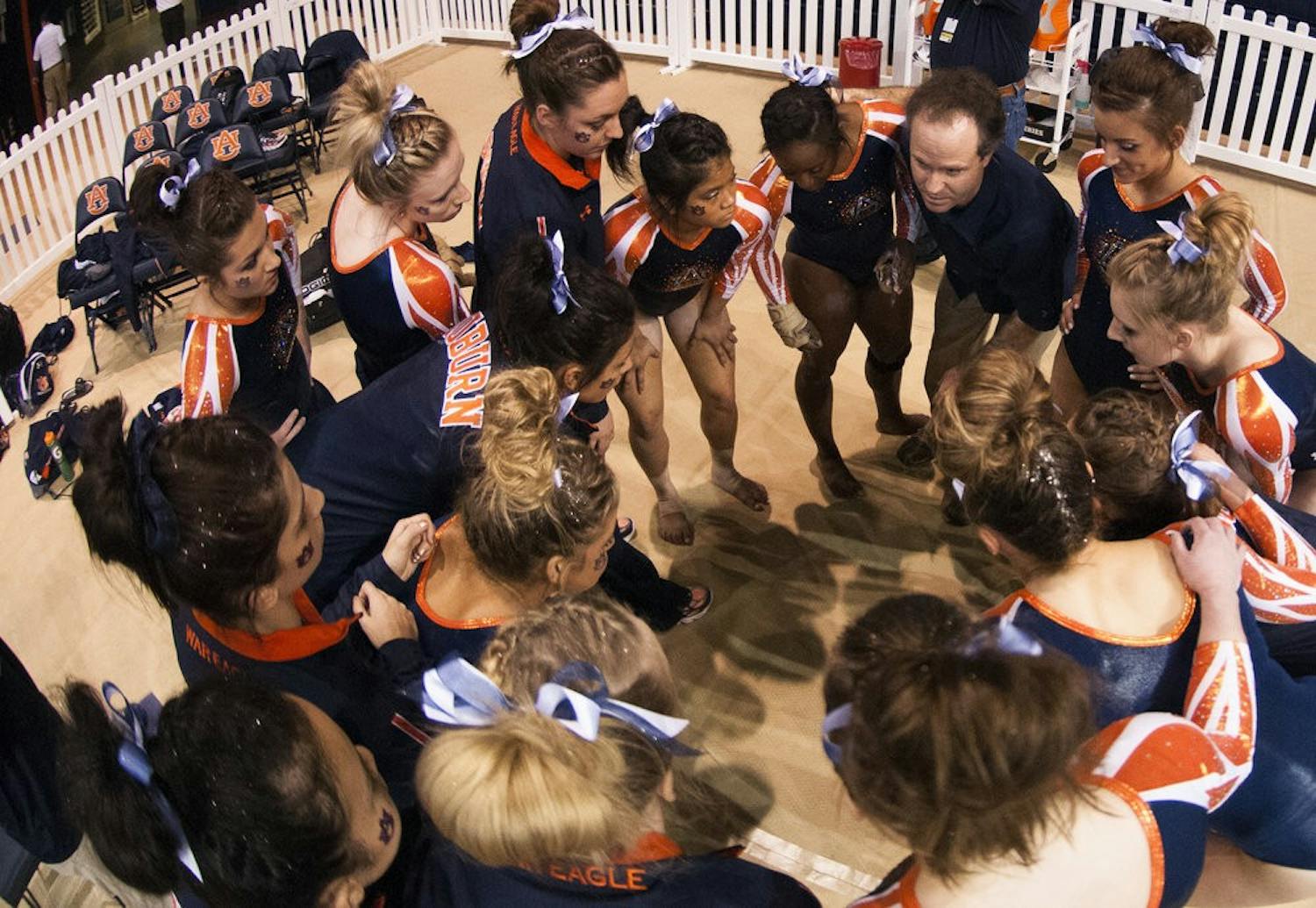 Coach Jeff Graba talks to his team after the beam routines, Jan. 10, 2014. (FILE PHOTO)