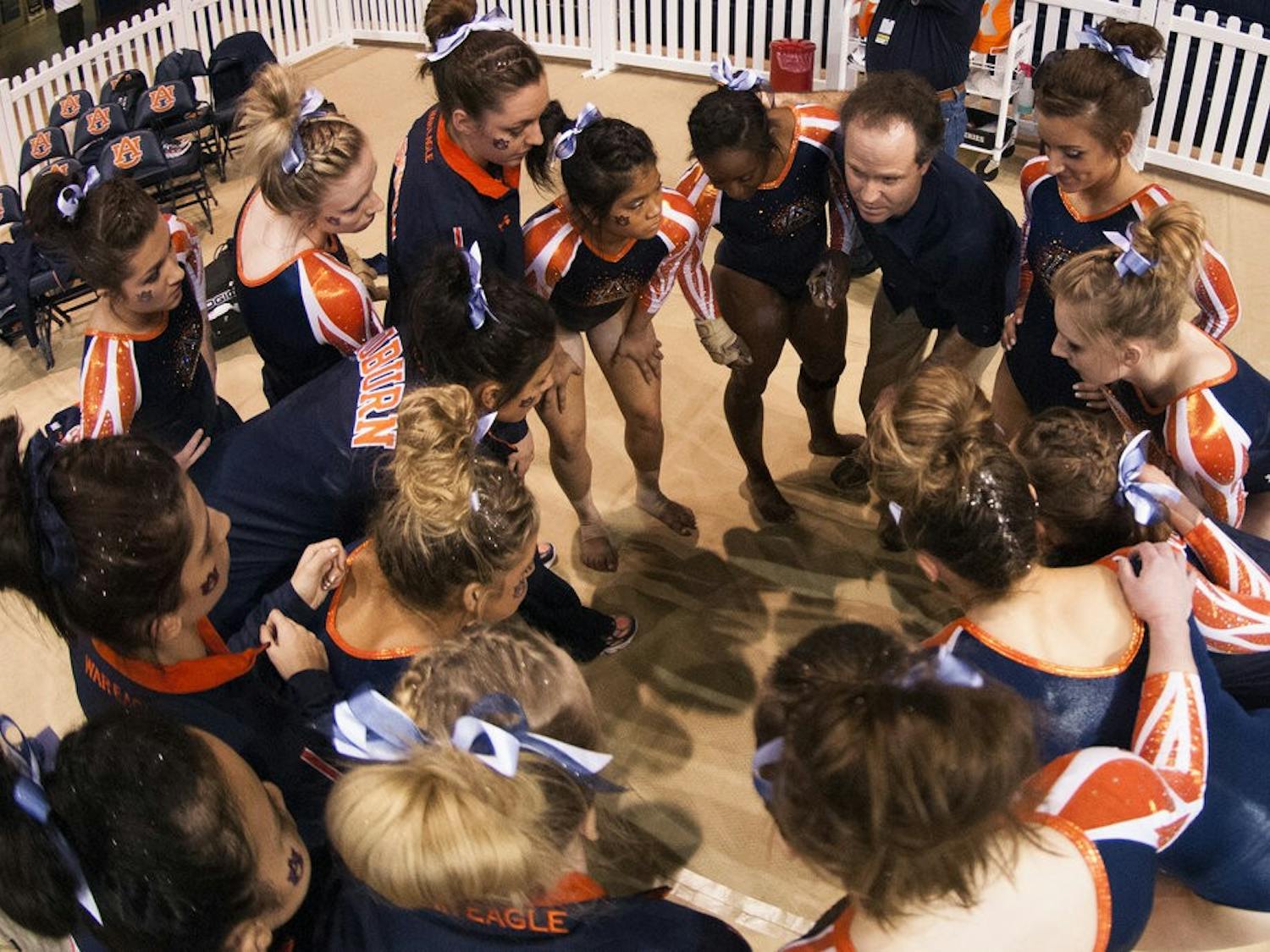 Coach Jeff Graba talks to his team after the beam routines, Jan. 10, 2014. (FILE PHOTO)