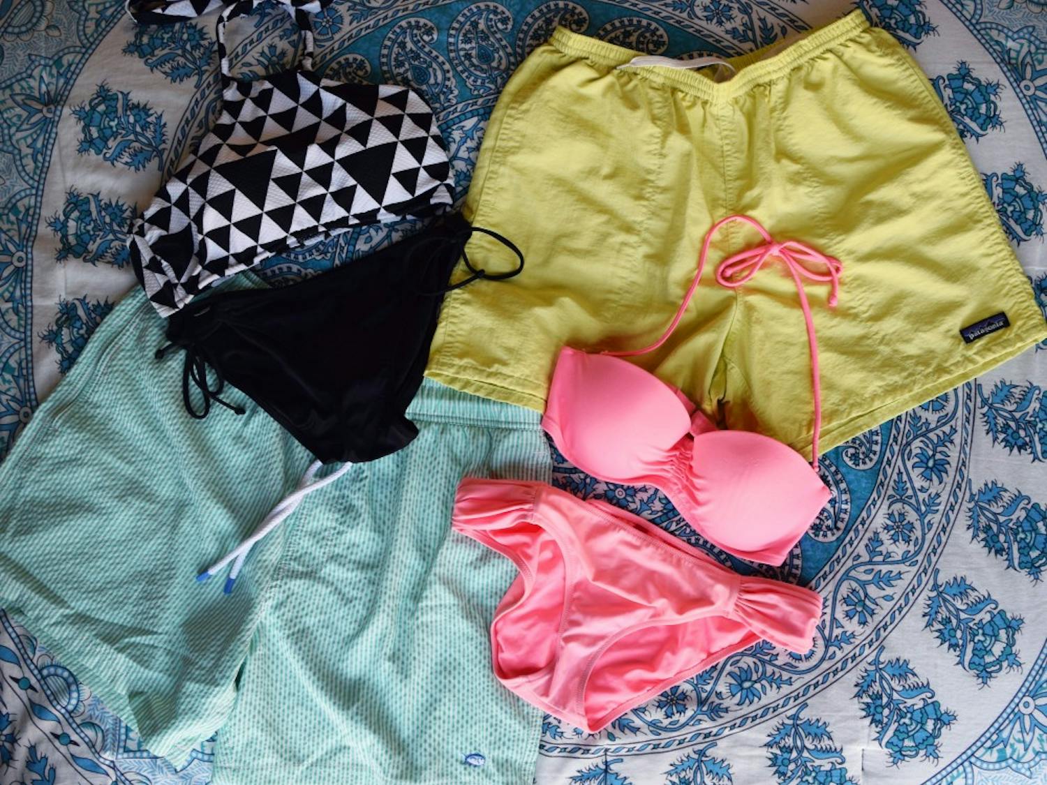 For girls, bandeau tops are popular.  For guys, Patagonia and Columbia shorts are in style.