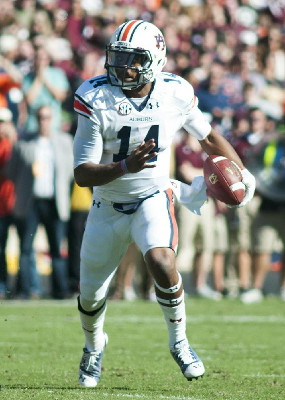 Auburn quarterback Nick Marshall (14) runs down the field against Texas A&M, Oct. 19, 2013. (Zach Bland / Photographer)
