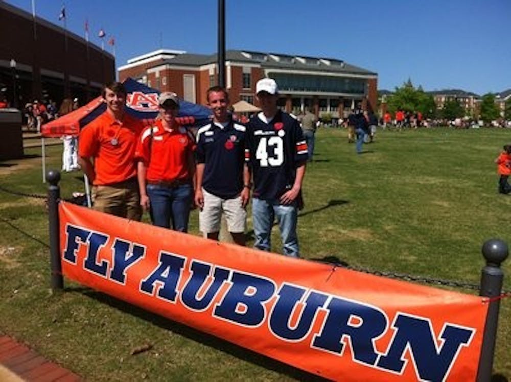 Left to Right: Michael Pfieffer, David Hoebelheinrich, Blake Schuette and BJ Kingston show their support for Auburn and the aviation program at a football game.
