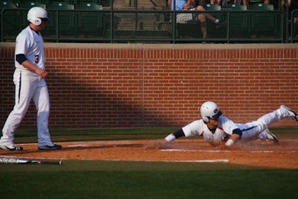 Auburn scores a run in front of a sellout, 4,096 person opening day crowd against UAB Friday, Feb. 18, 2011. (Rebekah Weaver / PHOTOGRAPHER)