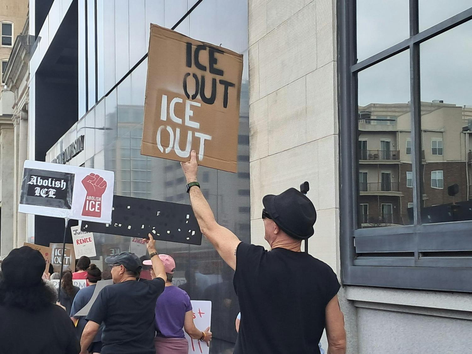 A man holds a sign reading "ICE out" during the "Say No 2 ICE" march on Feb. 21, 2026.