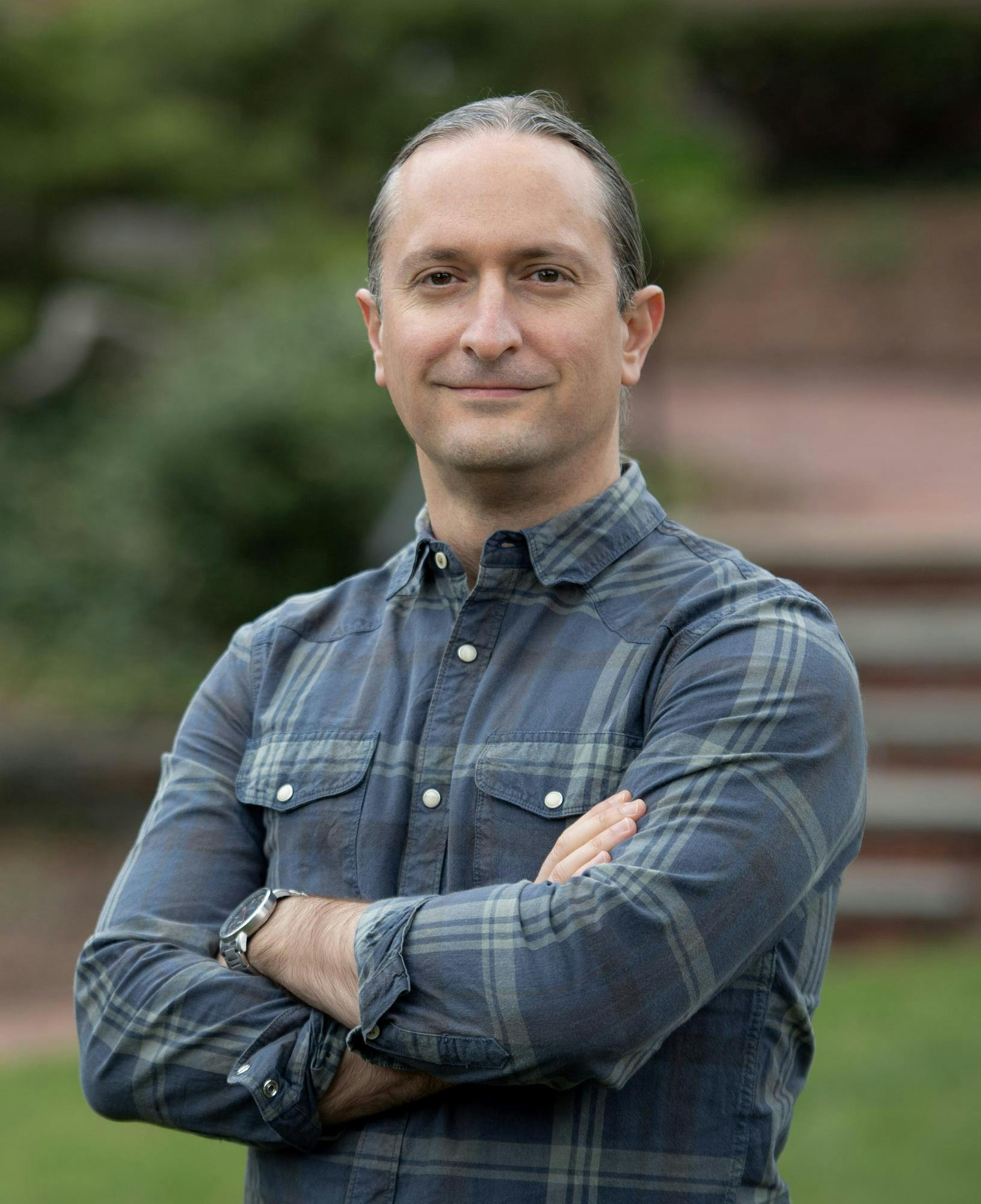 A portrait photo of Professor Andrew Scherer, a middle-aged man, outdoors. 