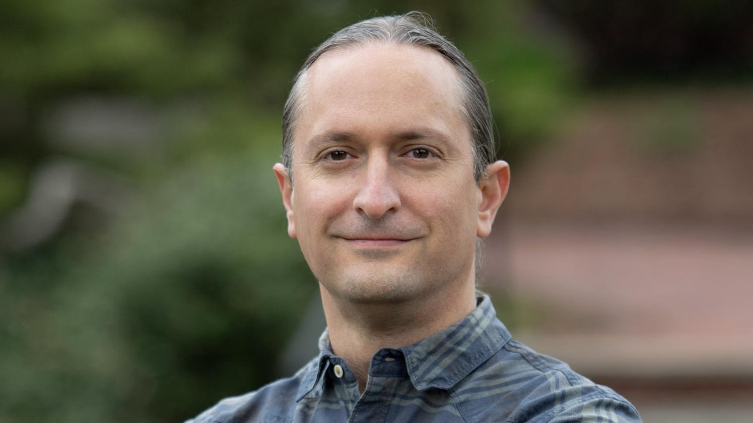 A portrait photo of Professor Andrew Scherer, a middle-aged man, outdoors.