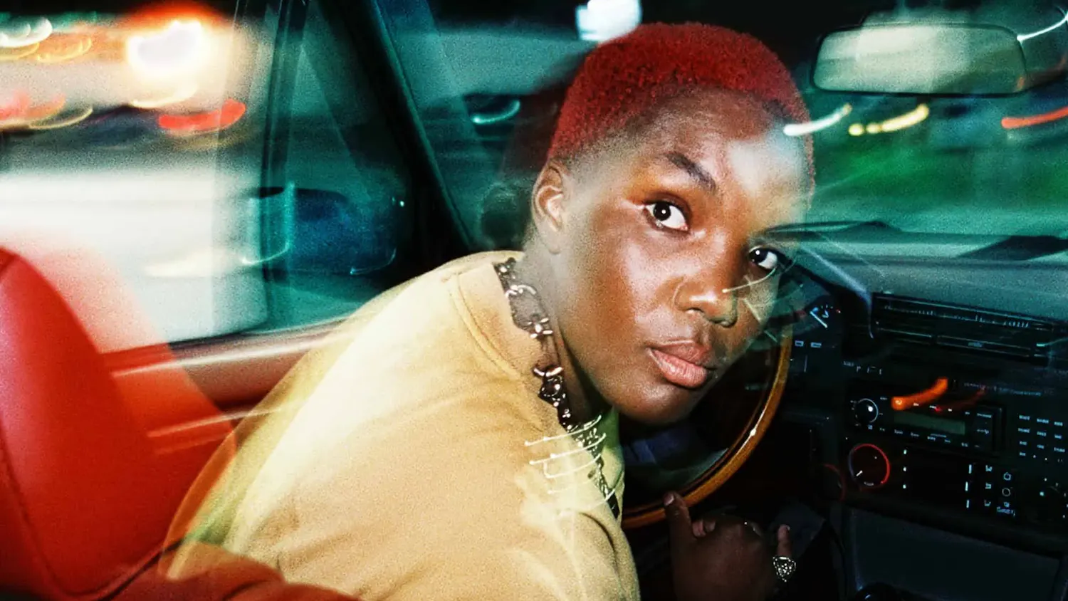 The “Ambiguous Desire” album cover, a photograph of Parks looking backwards from the driver's seat of a car.