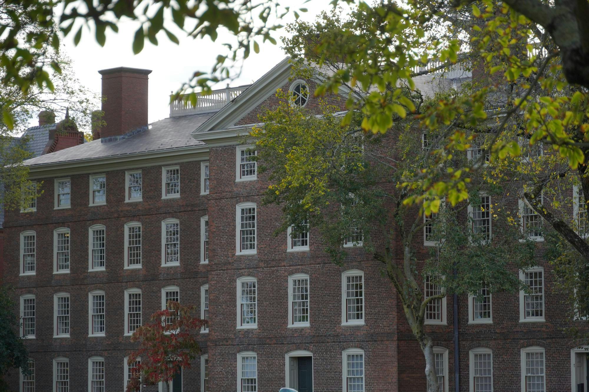 University Hall partially obscured by a tree. 