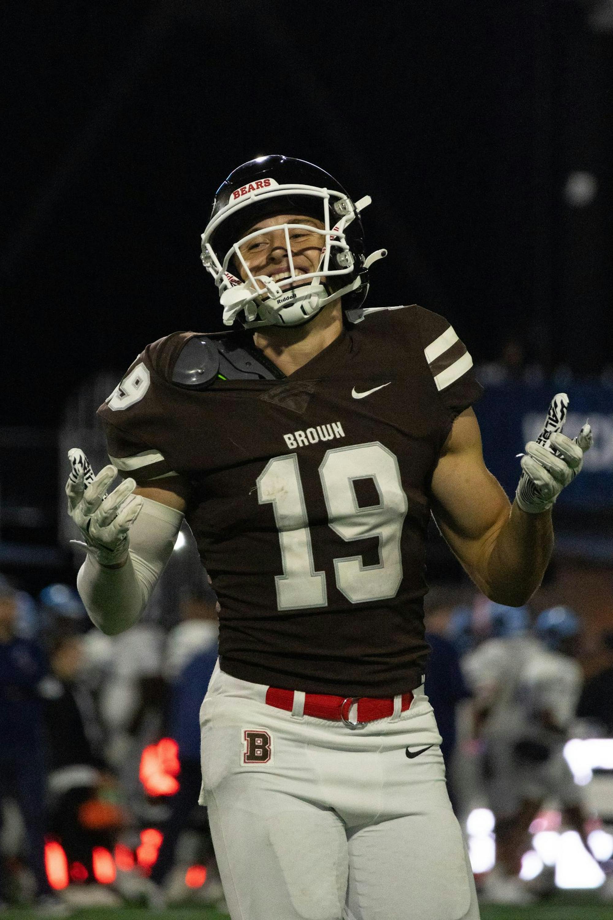 Wide receiver Tyler Pezza '26 smiles with his arms held wide.