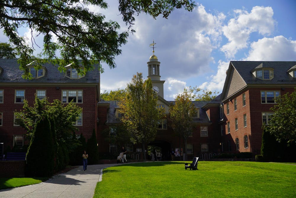 Photo of a green lawn and Wayland Arch on a sunny day.

