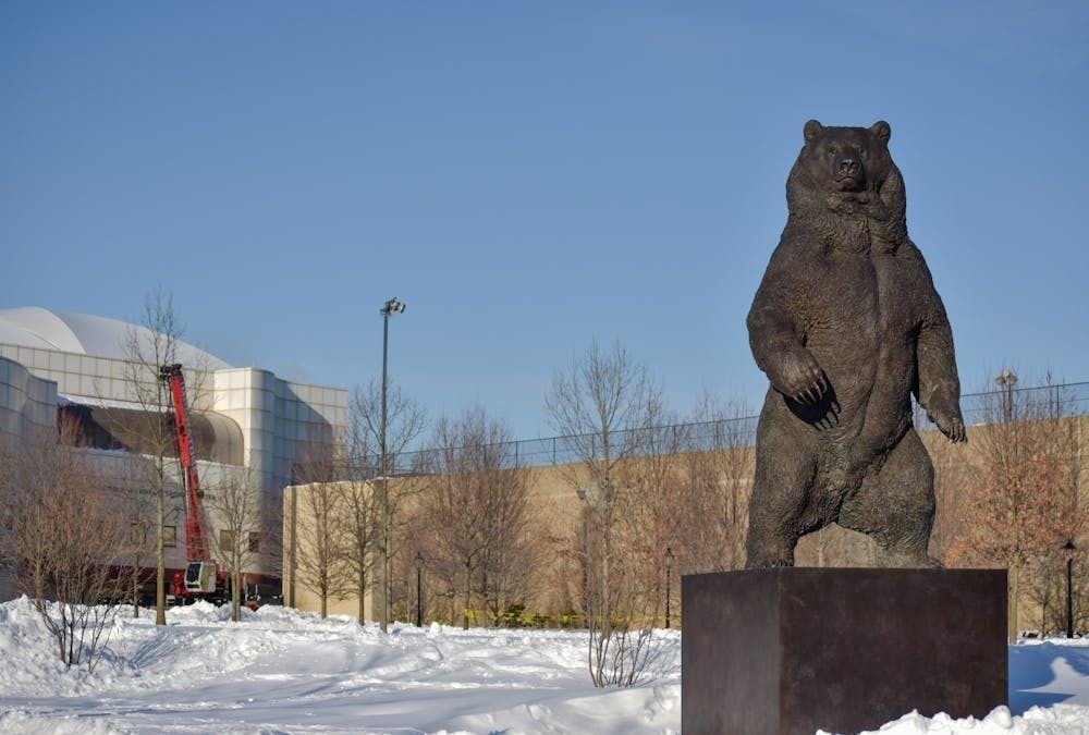 The Bear Statute on the athletics quad on a snowy day.