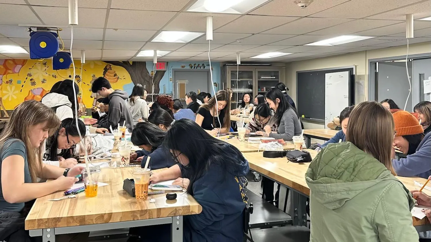 Photo of a classroom of students writing notes for dining hall workers.