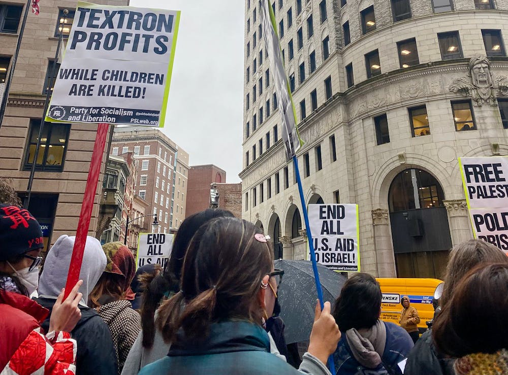 <p>Protestors carried signs calling for a ceasefire in Gaza and denouncing Textron’s connections with the Israeli military.</p><p></p>