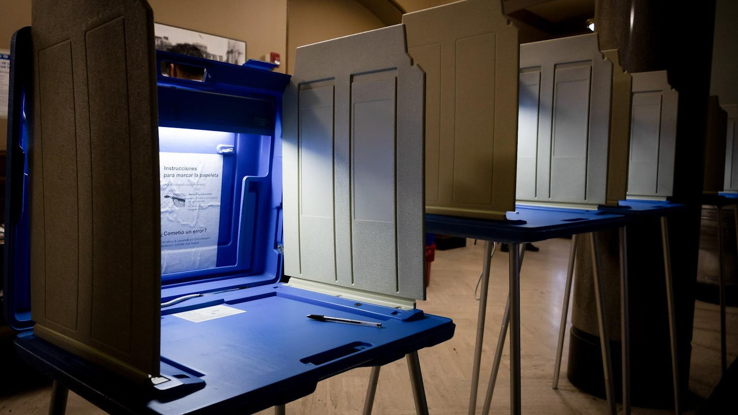 Photo of illuminated voting booths in the Providence City Hall.
