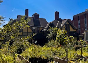 Photo of the Urban Environmental Lab, a yellow building with gardens in front of it.