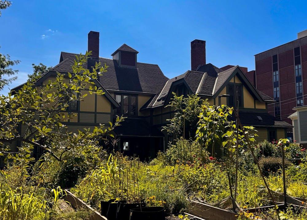 Photo of the Urban Environmental Lab, a yellow building with gardens in front of it.