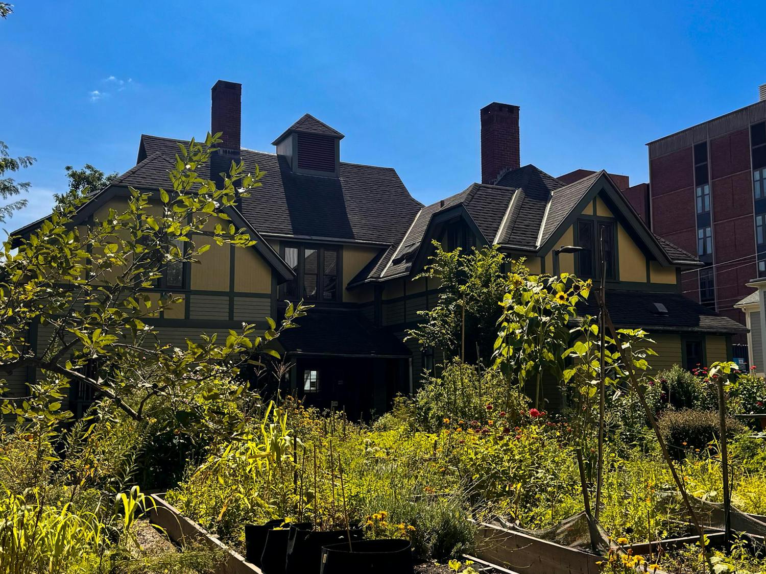 Photo of the Urban Environmental Lab, a yellow building with gardens in front of it.