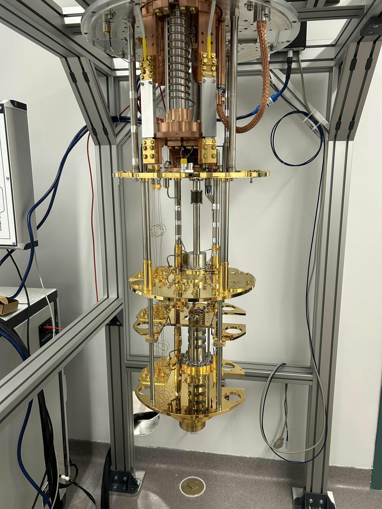 A lab set up for a quantum physics lab with a gold and shiny machine.