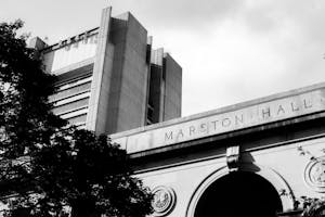 Black and white photograph of Marston Hall in the foreground, with the Sciences Library in the background