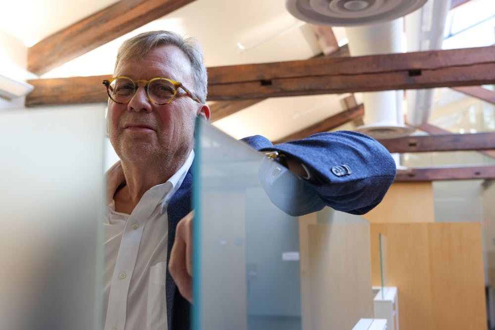 David Lindstrom leaning over a glass screen. 