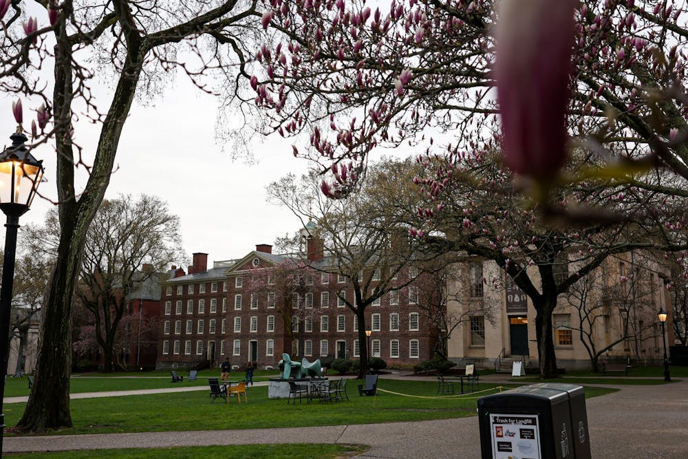 Photo of Brown’s campus with a large brick building in the center and green lawn in front.

