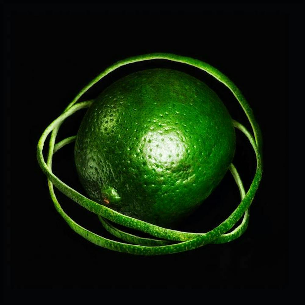 The album cover, which depicts a green lime with rings of lime peels around it. It stands out against a black background.