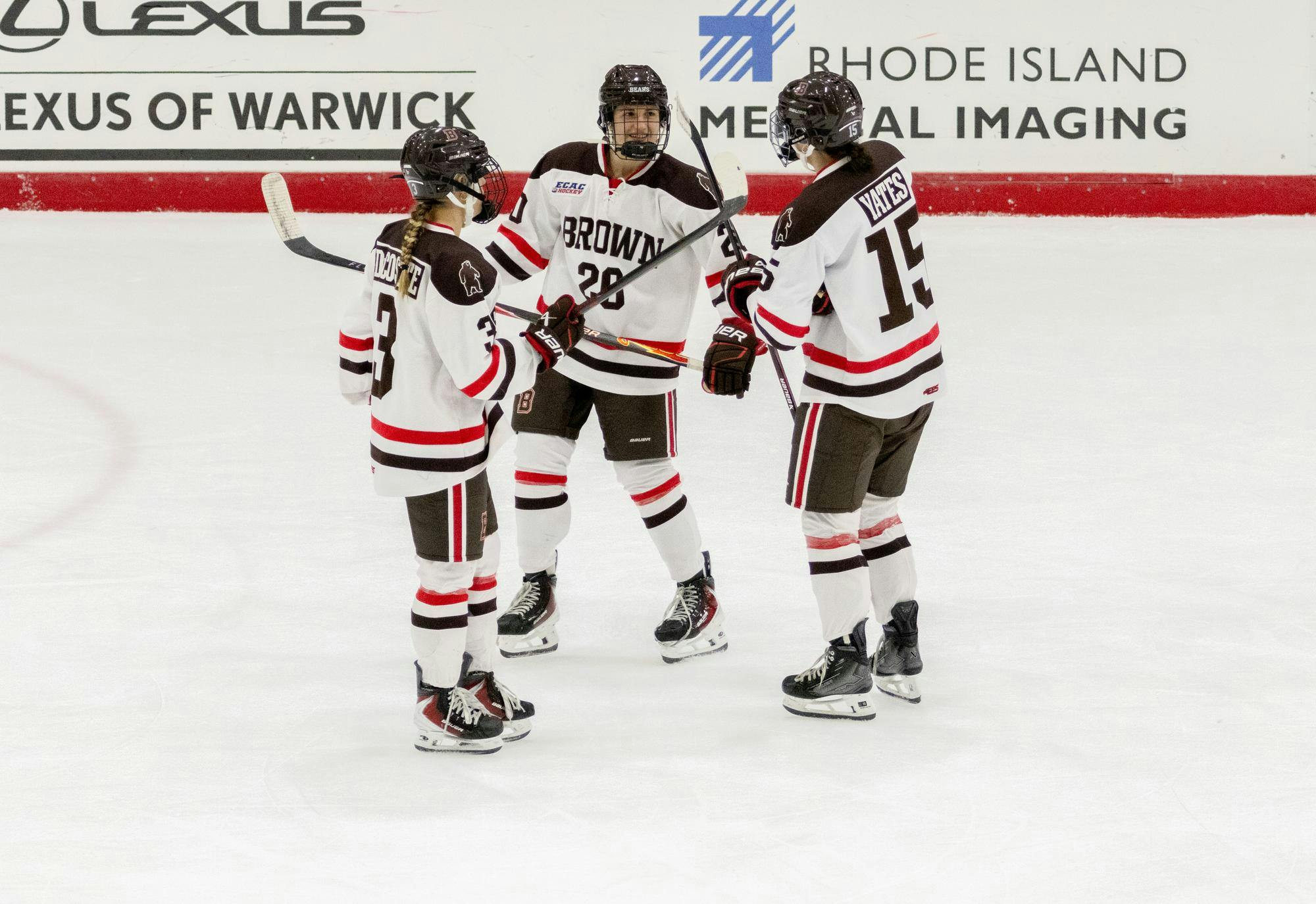 Three players go in for a celebration. 