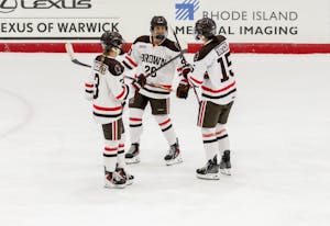 Three players go in for a celebration. 