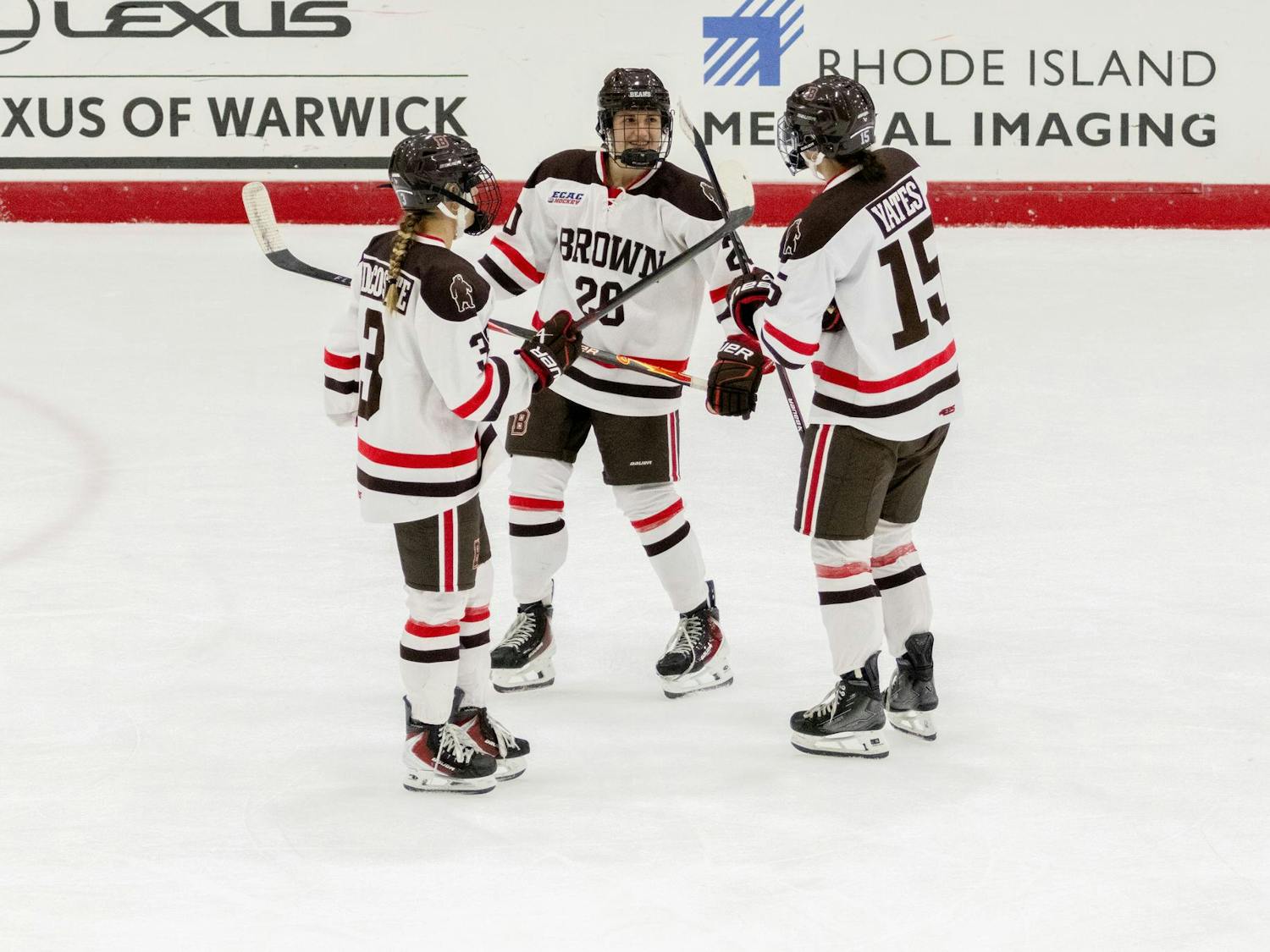 Three players go in for a celebration.