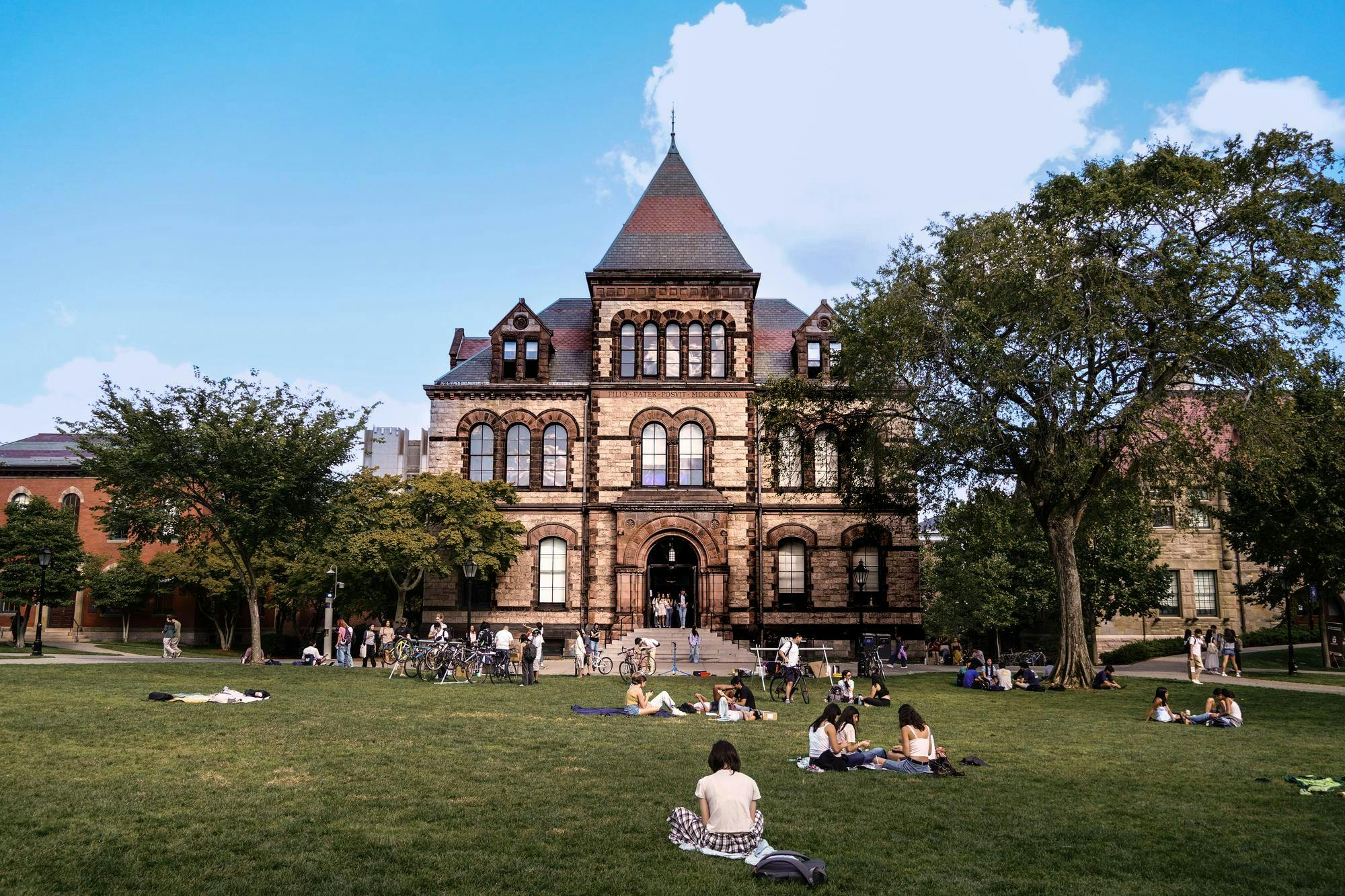 Students studying on the main green, Sayles Hall.
