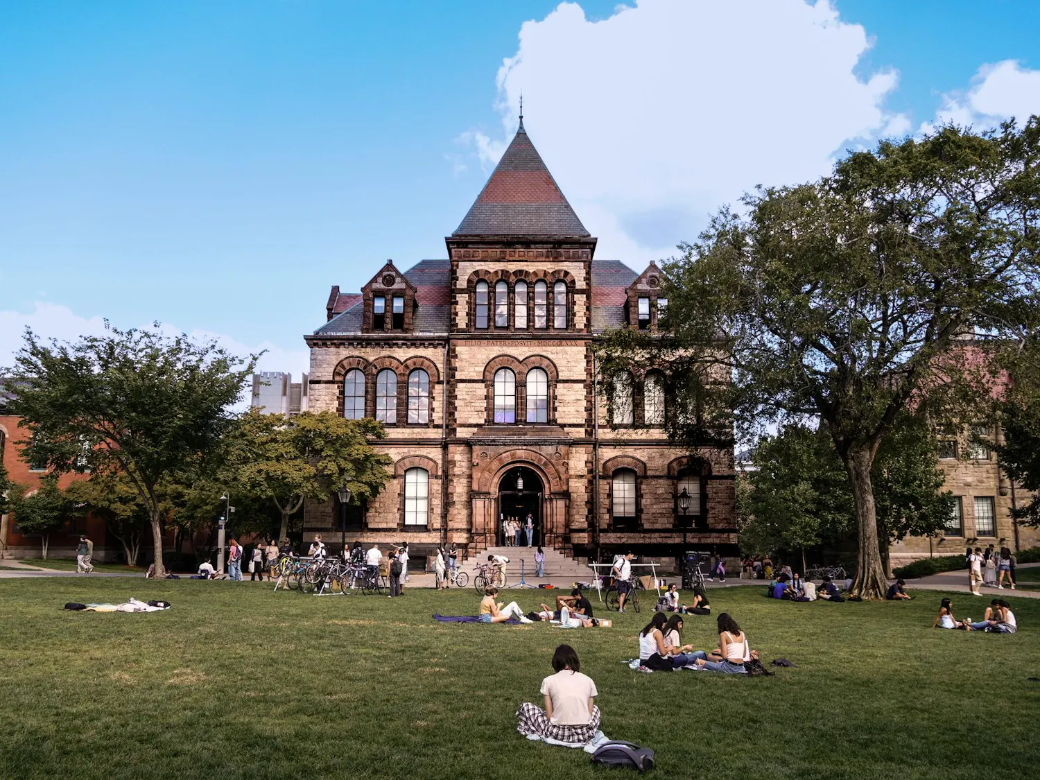 Students studying on the main green, Sayles Hall.