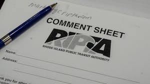 A pen is on top of a RIPTA comment sheet.