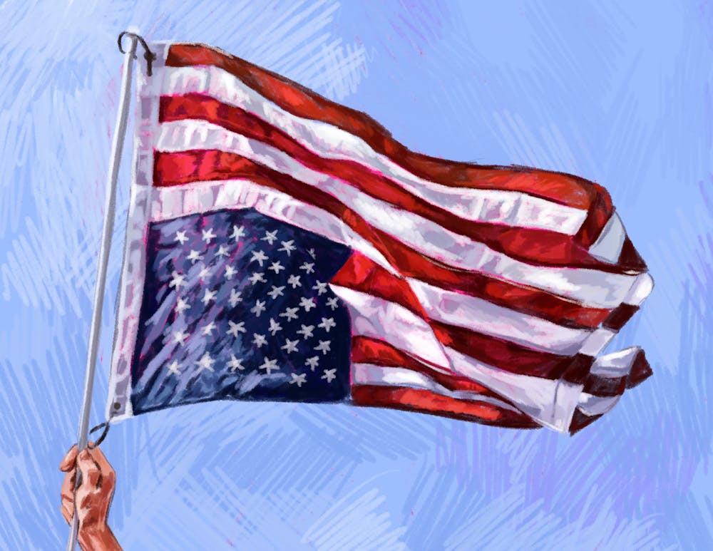 Hand waving an upside-down American flag. 