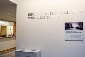 A photo shows the sign of the Student Health and Wellness Center.

