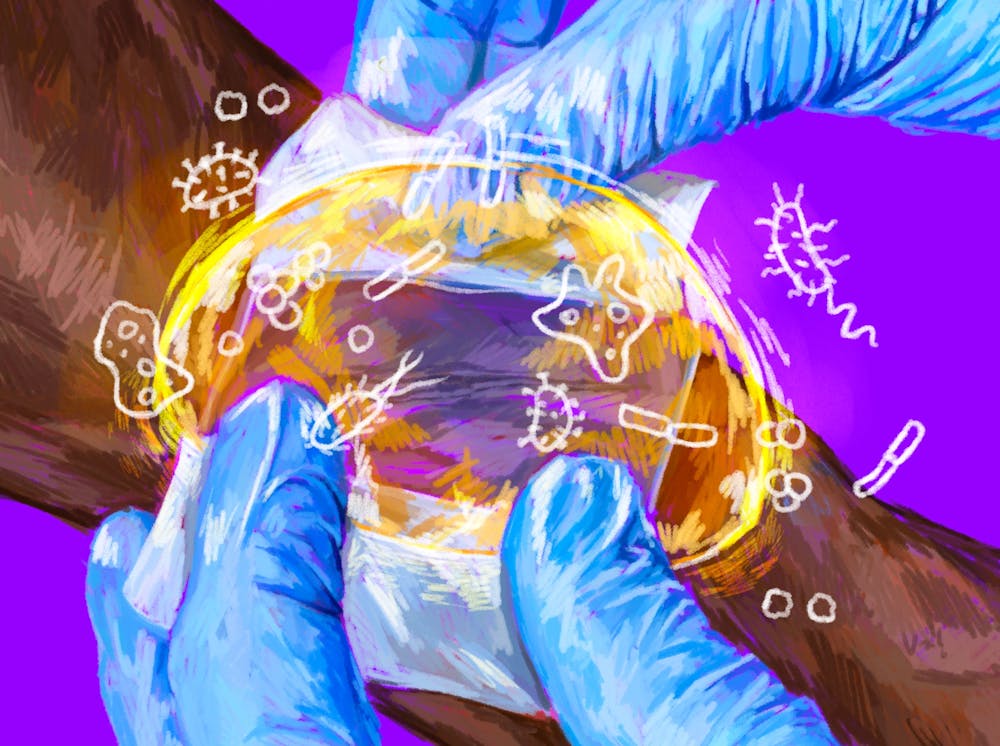 A drawing of blue gloved hands putting a bandage on skin with a bubble keeping bacteria out of the wound.