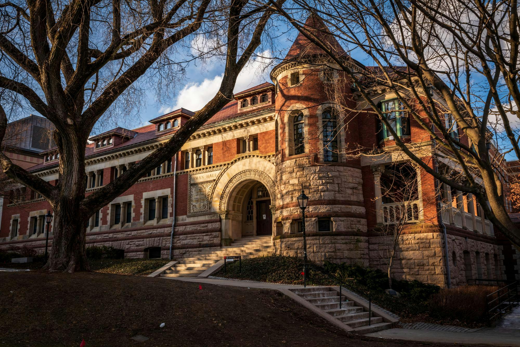Photo with a golden hue of Lyman Hall, a large, old brick building.

