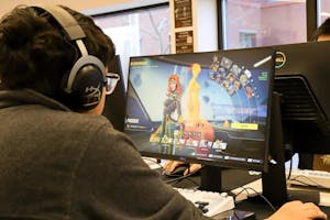 An over-the-shoulder photo of a student playing video games on a desktop.

