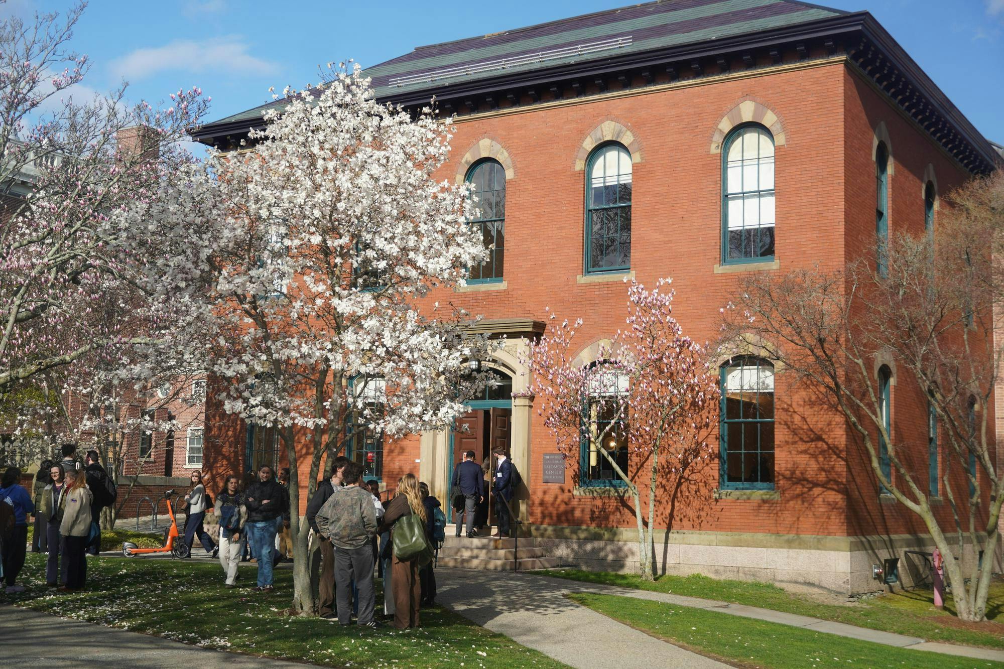 Students line up outside the Salomon Center for Learning on a bright spring day.